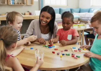 A woman works with young kids